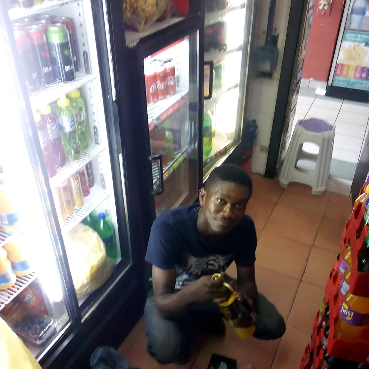 Mobile Fridge Repairs technician repairing a glass-door drinks fridge in a shop